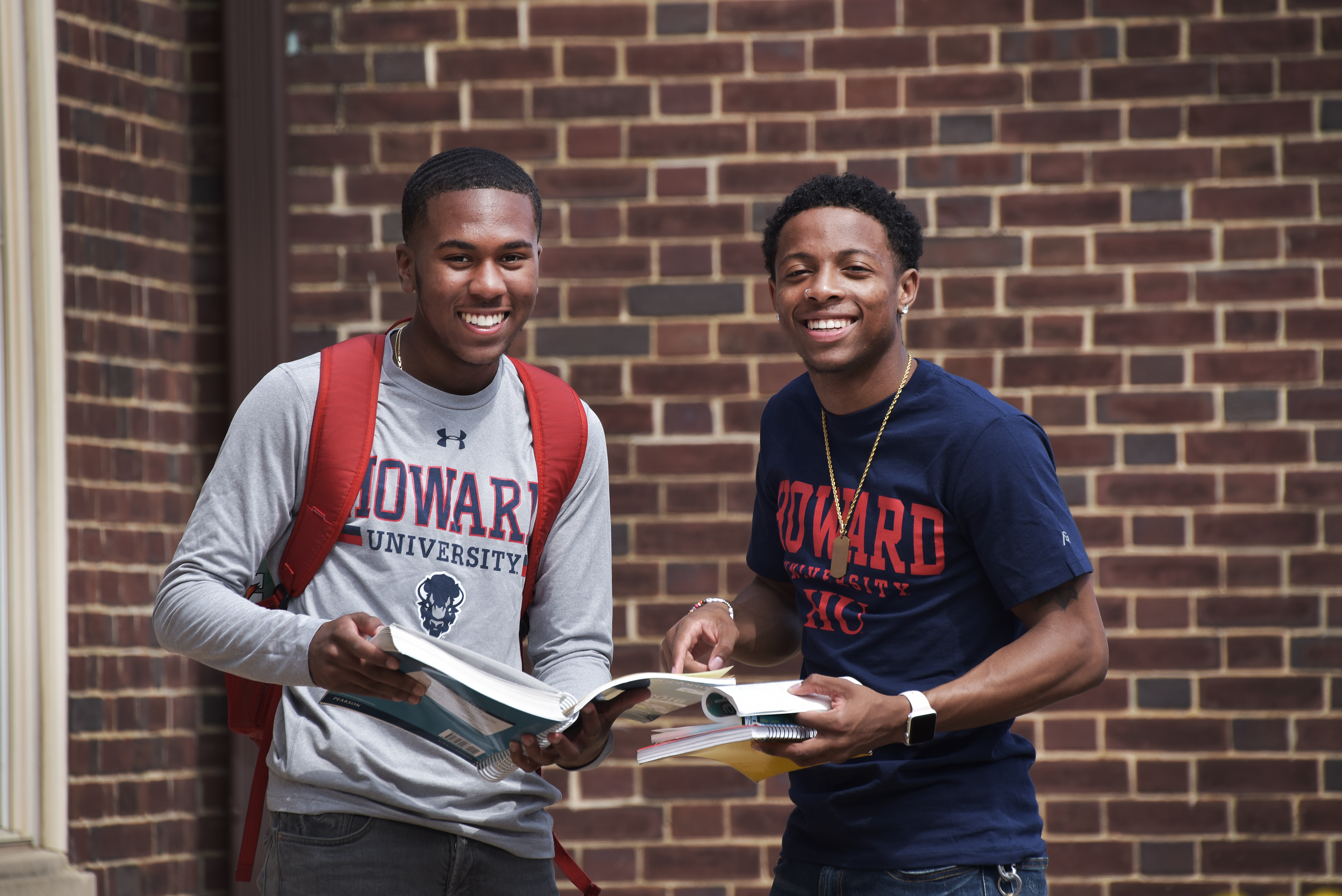 Two Howard Students looking at a magazine