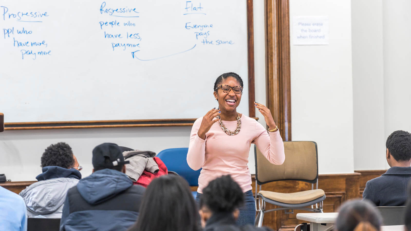Staff member interacting with students.
